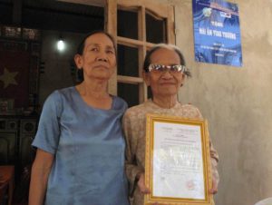 An extreme poor old lady received a friendship house built from MCNV microfinance projects in Ben Tre 2015